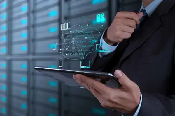 servers in rack with man reading tablet